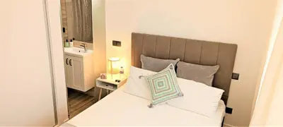 a small room with two beds and a television at Faro Comfy Ensuite Guest House in Faro