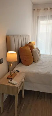 a large white bed with two towels on it at Faro Comfy Ensuite Guest House in Faro