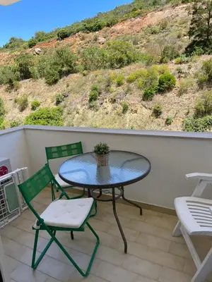 a patio with a table and two chairs on a balcony at The Best Downtown Albufeira in Albufeira