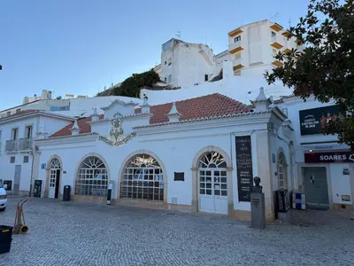 a white building on a cobblestone street at The Best Downtown Albufeira in Albufeira