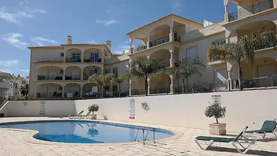 a large house with a swimming pool in front of it at São Vicente By Albufeira Rental in Albufeira