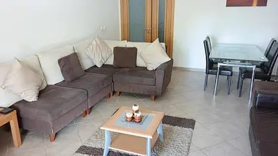 a living room with a couch and a table at São Vicente By Albufeira Rental in Albufeira