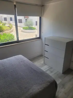 a bedroom with a bed and a dresser and a window at Apt-236 in Albufeira