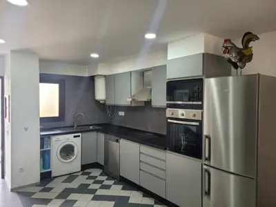 a kitchen with a refrigerator and a washing machine at Apt-236 in Albufeira