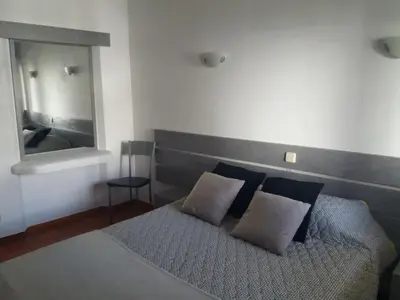 a bedroom with a bed with two pillows and a mirror at Apt-236 in Albufeira