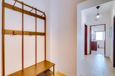 a room with glass doors and a wooden table at AL - Apartamento Portas do Mar in Quarteira