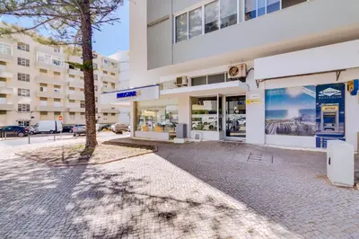 an empty street in front of a building at AL - Apartamento Portas do Mar in Quarteira