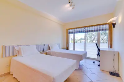 a hotel room with two beds and a window at AL - Apartamento Falésia Flat in Vilamoura