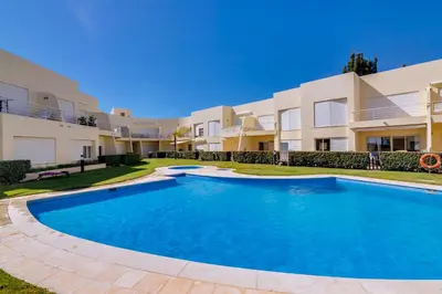 a large swimming pool in front of a building at AL - Apartamento Falésia Flat in Vilamoura