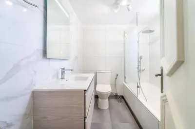 a white bathroom with a sink and a toilet at Villa Bougainvilla - Vilamoura - Pool - Free wifi - Air con in Quarteira
