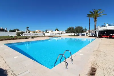 a large swimming pool in a resort at Villa Bougainvilla - Vilamoura - Pool - Free wifi - Air con in Quarteira