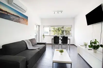 a living room with a couch and a tv at Apartamento Oceano in Albufeira