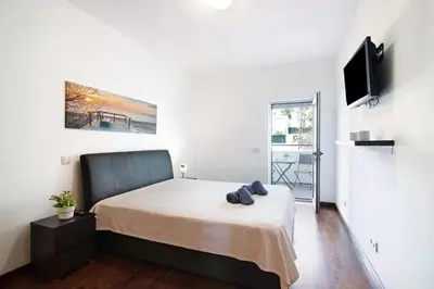 a bedroom with a bed and a flat screen tv at Apartamento Oceano in Albufeira