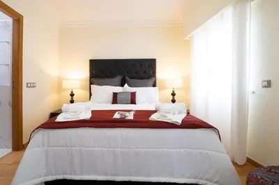 a bedroom with a large bed with a red blanket at Sunny, The House - AL in Faro
