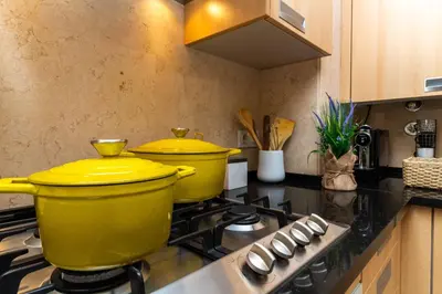 a kitchen with two yellow pots on a stove at Barracuda A14 in Albufeira