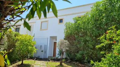 a white house with trees in front of it at Casa Relax à Olhos Albufeira in Albufeira