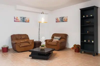 a living room with two chairs and a coffee table at JUDY - Albufeira in Albufeira