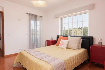 a bedroom with a bed with two pillows on it at JUDY - Albufeira in Albufeira