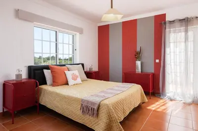 a bedroom with a bed and two windows at JUDY - Albufeira in Albufeira