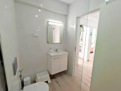 a white bathroom with a sink and a mirror at Lovely Terrace Apart. Downtown in Faro