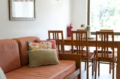 a living room with a couch and a dining room table at Alvaflor 102 - Vilamoura by HD Properties in Vilamoura