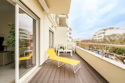 a yellow chair sitting on a balcony with a window at Albufeira, OLD TOWN - VERASOL N in Albufeira