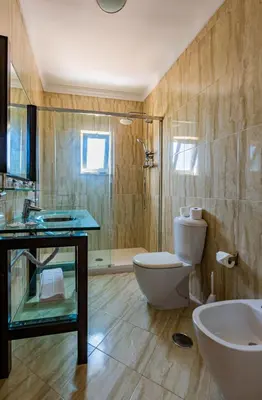 a bathroom with a toilet and a sink and a shower at Casa Colina 2 in Albufeira