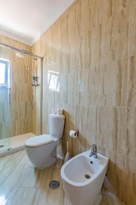a bathroom with a toilet and a sink and a shower at Casa Colina 2 in Albufeira