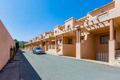 a car parked in front of a row of houses at Casa Colina 2 in Albufeira
