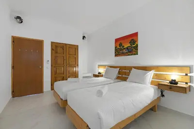 a bedroom with a large bed with white sheets at Pool side Villa Zara in Albufeira