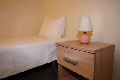 a bedroom with a bed and a lamp on a dresser at Apartamento T3 in Faro