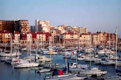 a bunch of boats docked in a harbor with buildings at Vilamoura-Praia da Falésia T2 in Quarteira