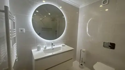 a white bathroom with a sink and a mirror at Sao Rafael T2 Duplex, Albufeira in Albufeira