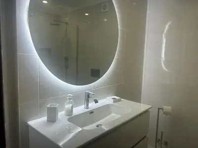 a white bathroom with a sink and a mirror at Sao Rafael T2 Duplex, Albufeira in Albufeira