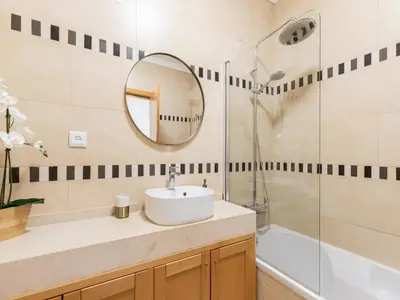 a bathroom with a sink and a shower and a mirror at Akisol Olhos de Água Lyrical in Albufeira