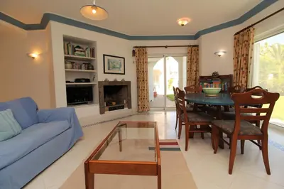 a living room with a blue couch and a table at SÃO RAFAEL BEACH VILLAGE 131 - Apartamento T2 Praia de São Rafael - Albufeira in Albufeira