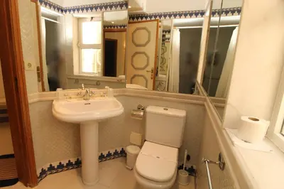a bathroom with a sink and a toilet and a mirror at SÃO RAFAEL BEACH VILLAGE 131 - Apartamento T2 Praia de São Rafael - Albufeira in Albufeira