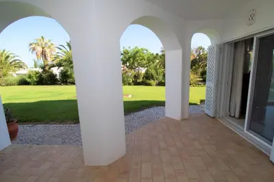 an arched entry way to a house with a lawn at SÃO RAFAEL BEACH VILLAGE 131 - Apartamento T2 Praia de São Rafael - Albufeira in Albufeira