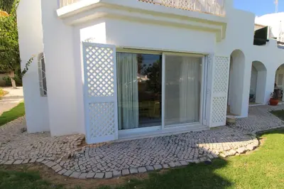 a white house with a sliding glass door at SÃO RAFAEL BEACH VILLAGE 131 - Apartamento T2 Praia de São Rafael - Albufeira in Albufeira