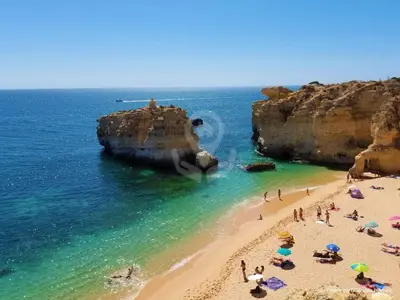 a group of people on a beach near the ocean at SÃO RAFAEL BEACH VILLAGE 131 - Apartamento T2 Praia de São Rafael - Albufeira in Albufeira