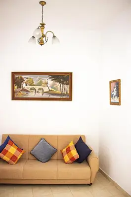 a couch in a living room with a painting on the wall at Casa Clementina in Albufeira