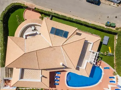 a large white house with stairs and a porch at Villa Cavi in Olhos de Água