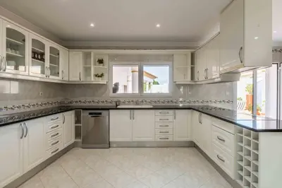 a white bathroom with two sinks and a shower at Villa Cavi in Olhos de Água
