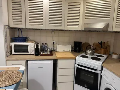 a kitchen with a stove and a microwave at LV Apartment Albufeira in Albufeira