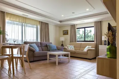 a living room with a couch and a table at Pine Sun Park Т1 apartment Falesia beach in Olhos de Água