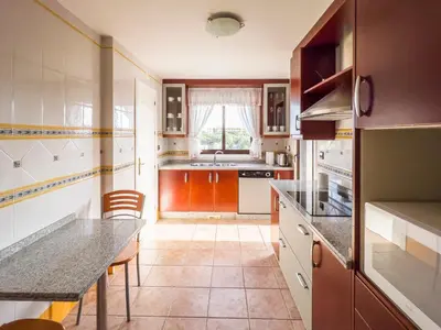 a kitchen with a table and a counter top at Pine Sun Park Т1 apartment Falesia beach in Olhos de Água