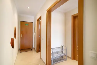 a hallway with a door and a bench in a room at Yara Beach Apartments T1 in Albufeira