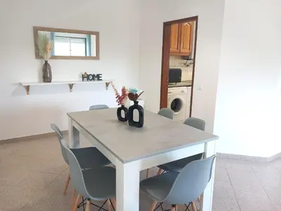a dining room table with blue chairs and a table at Apartamento Jade by Sunnyway in Albufeira