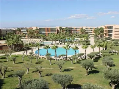 an aerial view of a resort with a pool and palm trees at Herdade dos Salgados - 2 Bedroom in Guia