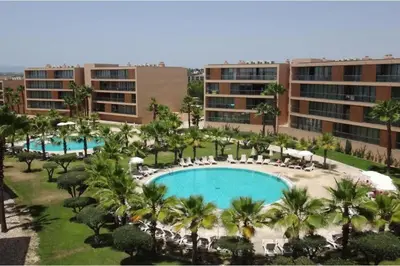 an aerial view of a resort with two pools and palm trees at Herdade dos Salgados - 2 Bedroom in Guia